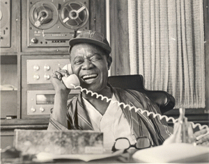 Pops on the phone - Photo by Jack Bradley, Courtesy of Louis Armstrong House Museum