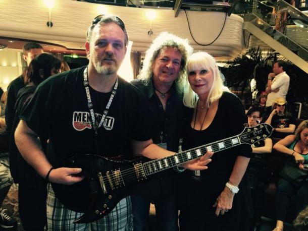 Dave Meniketti of Y&T (center) and Wendy Dio pose with Monsters of Rock Cruise passenger Richard Wesson, winning bidder for the George Bisceglia custom DIO guitar