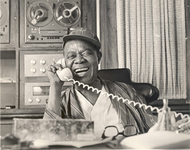 Pops on the phone - Photo by Jack Bradley, Courtesy of Louis Armstrong House Museum