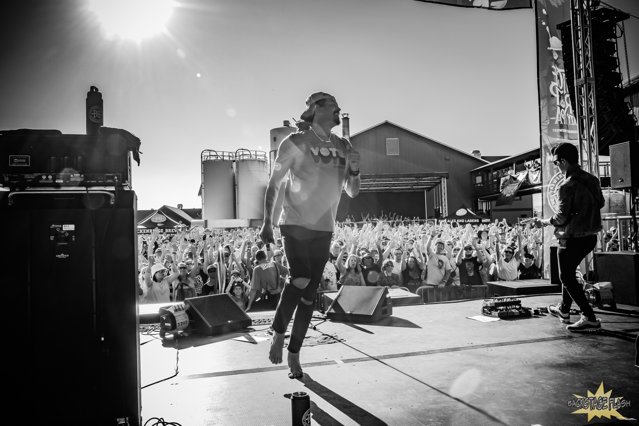 Michael Franti singing and dancing in the Colorado sun