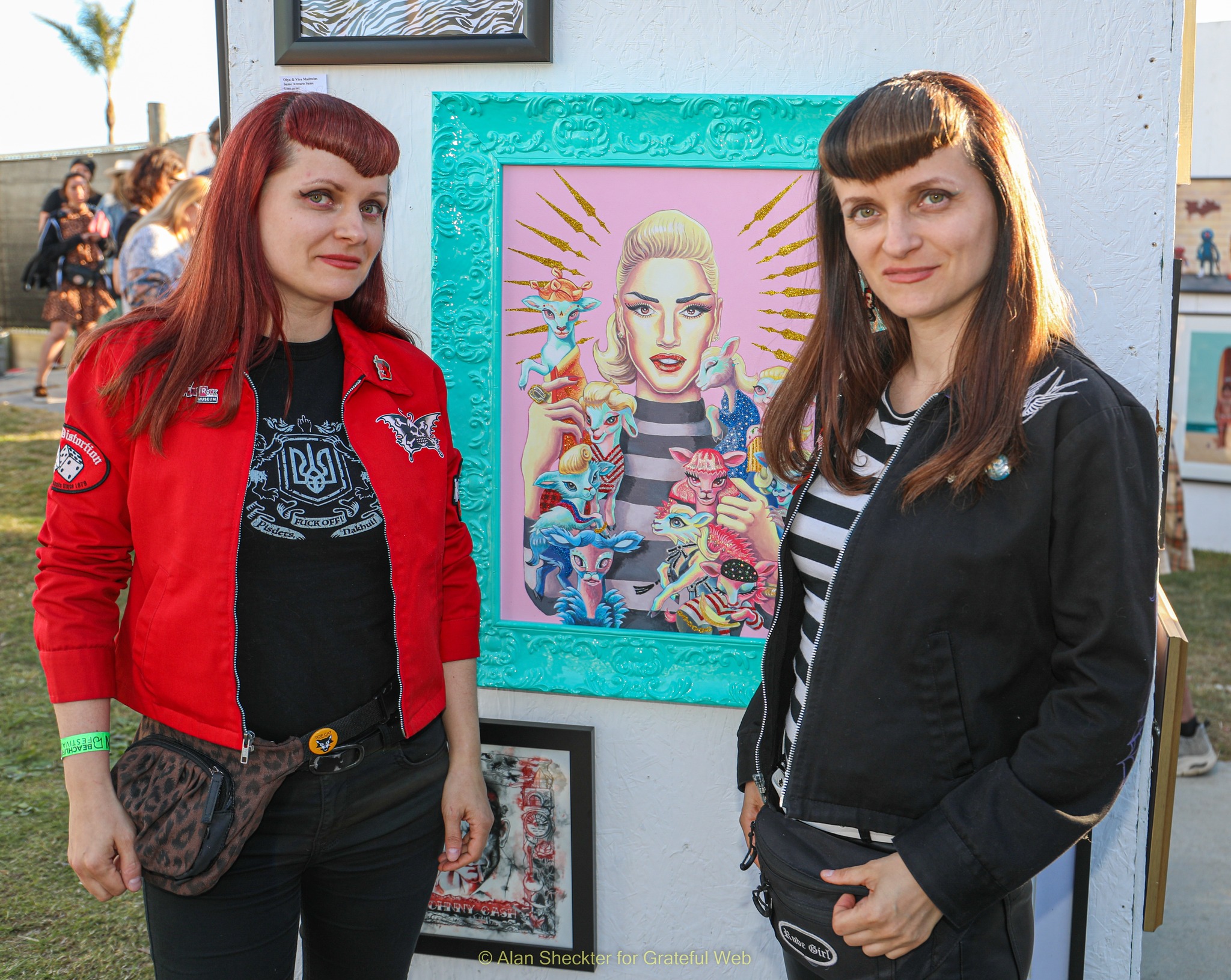 The Mad Twins – Olya and Vira – pose with a piece of their art depicting Gwen Stefani