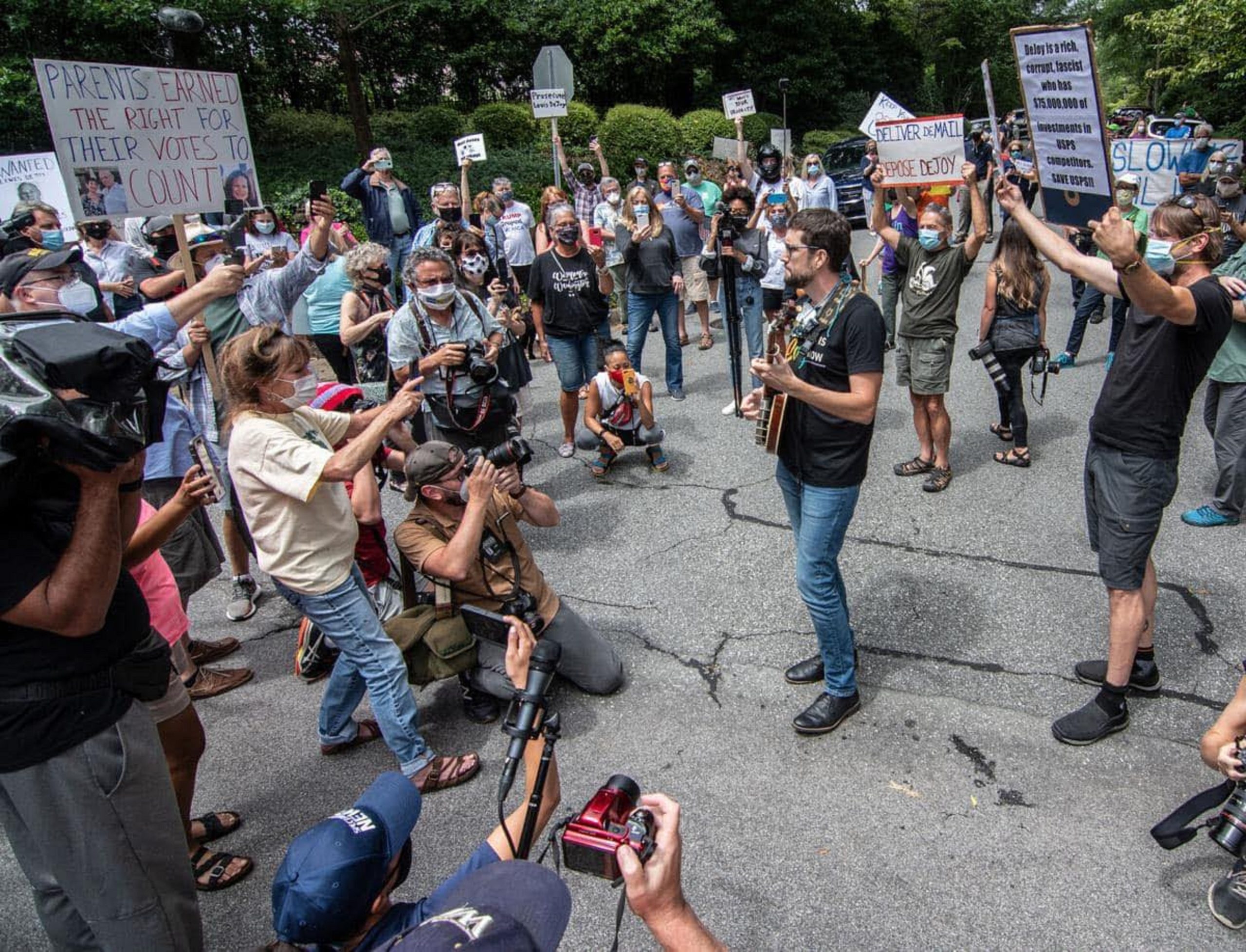 Joe Troop's song to save the USPS goes viral at North Carolina protest outside DeJoy's mansion