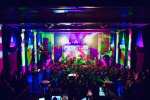 Double Dose: Photon & RADO Interlock for a Cosmic Night of Exploration at the Bluebird