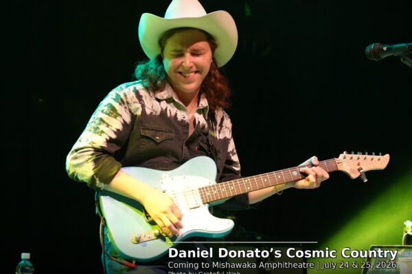 Musician in a white cowboy hat plays a light blue electric guitar on stage; overlay shows 'Daniel Donato’s Cosmic Country' concert info.