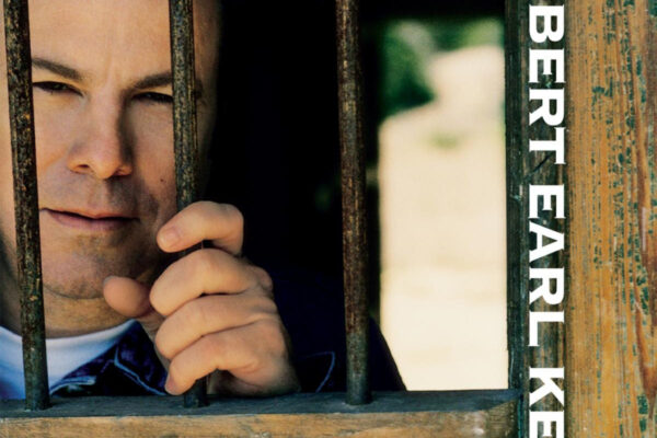 Album cover: a man peers through rusted bars; 'gravitational forces' text at bottom and vertical 'Robert Earl Keen' along the right edge.