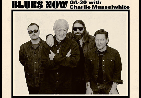 Poster-style band photo: GA-20 with Charlie Musselwhite, four men in dark jackets pose together under the headline 'BLUES NOW'.