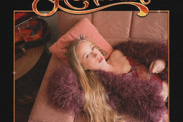 Album cover art for Bronwyn featuring a blonde woman in burgundy lace with a purple feathered coat reclining on a pink sofa; a guitar rests to the left, a black background with a gold-framed edge and the stylized gold title at the top reading Bronwyn.