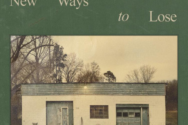 Album cover: American Aquarium's 'New Ways to Lose' with a vintage white garage building on a green textured background.