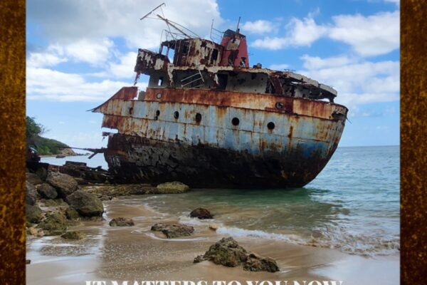 Rusty, derelict shipwreck on a sandy beach with a blue sky; album by Cary Morin, It Matters to You Now.