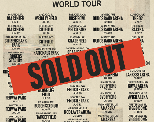 Noah Kahan 'The Great Divide' World Tour poster with many tour dates; a red diagonal 'SOLD OUT' stamp across the center.