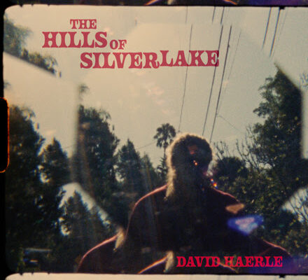 Album cover for The Hills of Silverlake by David Haerle, showing a silhouetted figure reflected in glass with trees and power lines in the background.