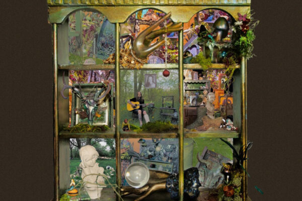 A vintage cabinet filled with a crowded, surreal collage of objects—plants, sculptures, instruments, and a person playing guitar in the central pane.